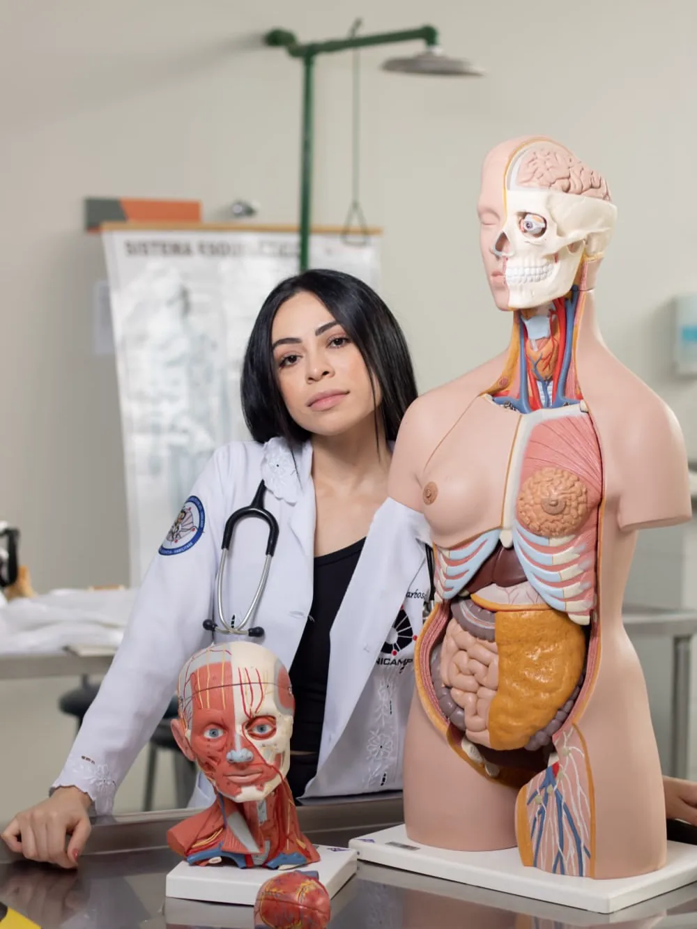 Dra. Karen Barbosa de jaleco branco no consultório clínico